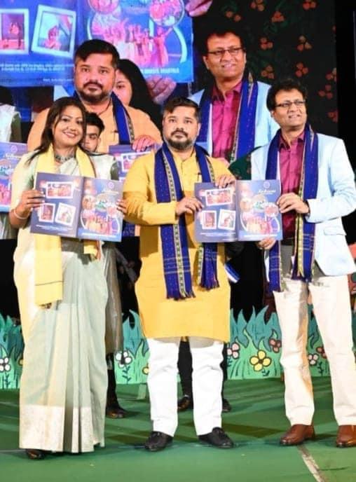 Team on stage unveiling a commemorative publication