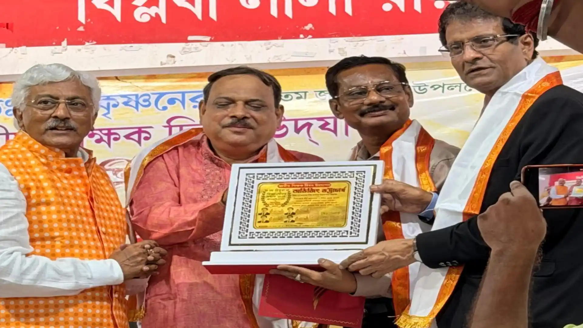 Award citation being presented to Abhijit Bhattacharjee